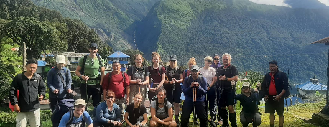 A trekking group gathered outside Hotel Magnificent